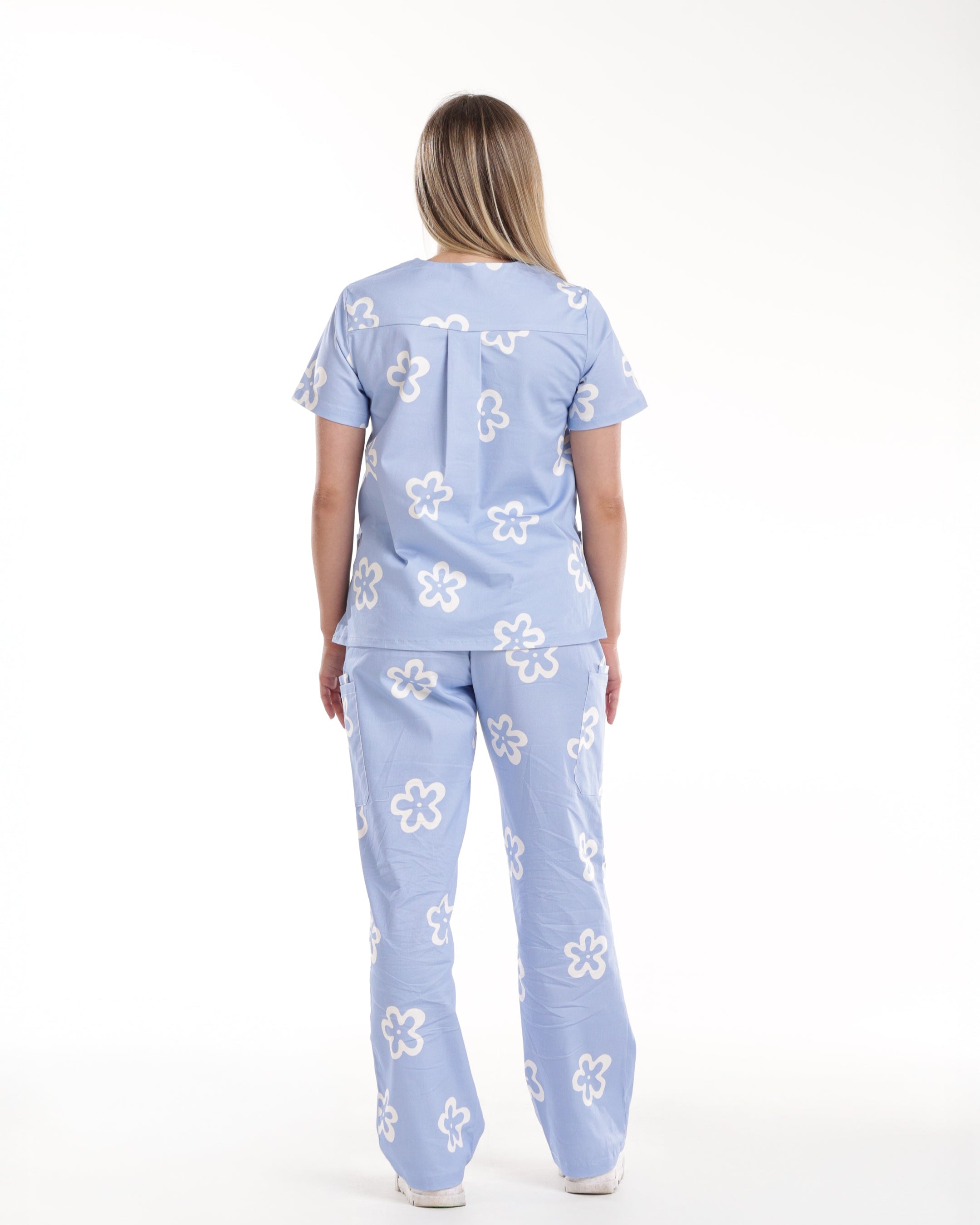 Back view of Bennie Daisy Scrub Set in blue floral print, highlighting top and pants fit from the Debut Collection