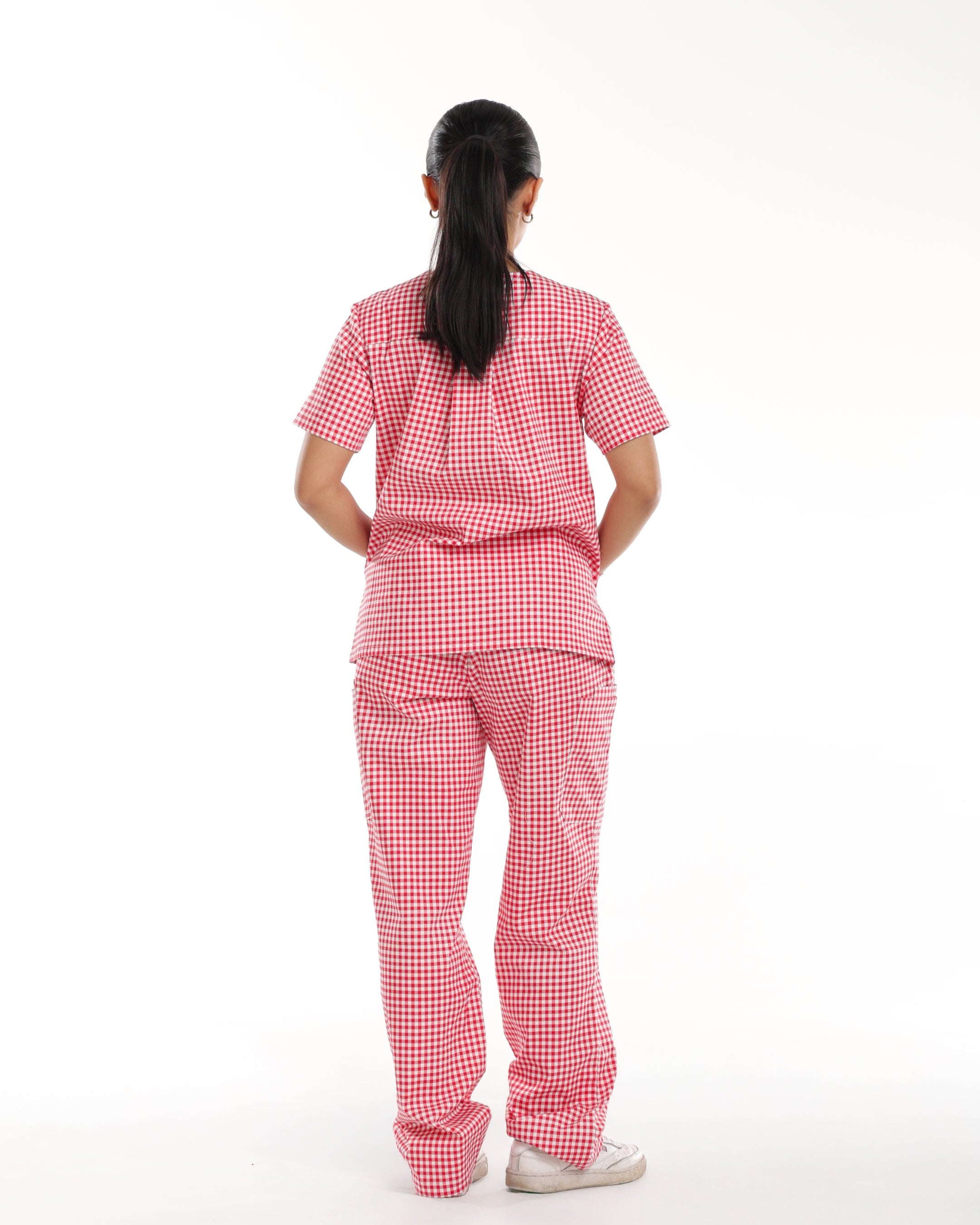 Back view of Bennie Ruby Scrub Set in red checkered gingham, highlighting fit and design of top and pants. 