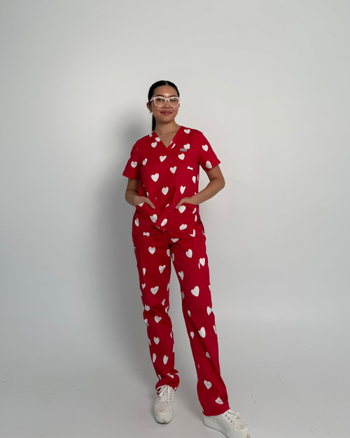Model wearing Bennie Valentina Scrub Set  in red with white heart print, full body front view of medical scrubs 